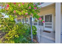 Charming condo entrance with vibrant landscaping and inviting front door at 5695 40Th N Ave # 301, Kenneth City, FL 33709