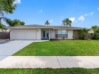 Charming single-story home featuring a manicured front yard and attached garage at 9109 134Th Way, Seminole, FL 33776