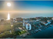Stunning beach house aerial view near tennis courts, marina, and sparkling Gulf of Mexico at 19111 Whispering Pines Dr, Indian Shores, FL 33785