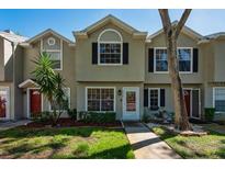 Charming townhome featuring a well-maintained front yard and a welcoming entrance at 2175 Fox Chase Blvd, Palm Harbor, FL 34683