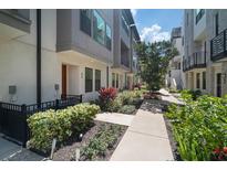Modern townhouse exterior featuring well-maintained landscaping and neutral color palette at 2511 N Grady Ave # 43, Tampa, FL 33607