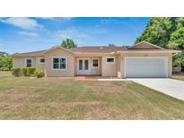 Charming single story home featuring a manicured lawn and an attached two car garage at 2627 Hancock St, Plant City, FL 33563
