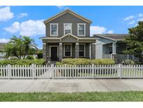 Charming two-story home featuring a stone-accented porch and well-maintained landscaping with a white picket fence at 2706 Lantern Hill Ave, Brandon, FL 33511