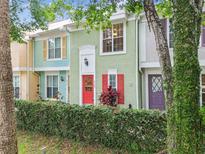 Charming townhouse with colorful facade, vibrant doors, and shutters, surrounded by lush greenery at 3308 W Wyoming Cir, Tampa, FL 33611