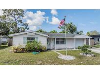 Charming single-story home featuring a well-maintained lawn and welcoming facade at 5414 Oceanic Rd, Holiday, FL 34690