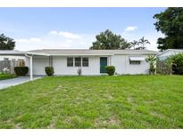 Charming single-story home with fresh exterior paint, a well-maintained lawn, and carport at 5627 57Th N Ave, St Petersburg, FL 33709
