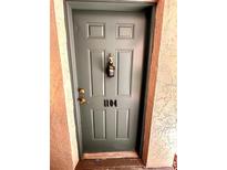 Exterior front door of unit 1104 with a lockbox for convenient access at 720 Lyndhurst St # 1104, Dunedin, FL 34698