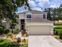 Charming two-story home featuring a neutral color palette, well-manicured landscaping, and a spacious two-car garage at 8222 Haven Harbour Way, Bradenton, FL 34212