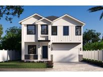 New construction home with white siding, black trim, two-car garage, and a stone base at 905 N Willow Ave, Tampa, FL 33606