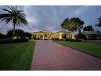 Spacious single-story home with a large driveway, mature landscaping, and great curb appeal at 12713 Grand Traverse Dr, Dade City, FL 33525