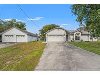 Charming single-story home with attached and detached two-car garages at 13991 Coronado Dr, Spring Hill, FL 34609