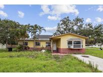 Charming single-story home featuring a red brick foundation, a bay window, and a well-lit entryway at 1560 Connecticut Ne Ave, St Petersburg, FL 33703