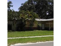 Single-Gathering home with a well-kept lawn, presenting an attractive exterior in a peaceful neighborhood setting with mature trees at 1560 Connecticut Ne Ave, St Petersburg, FL 33703