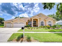 Charming single Gathering home with manicured lawn and three car garage at 17302 Stetson Ln, Odessa, FL 33556