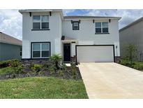 Charming two-story home featuring manicured landscaping and a well-maintained lawn in a desirable neighborhood at 17807 Canopy Pl, Bradenton, FL 34211