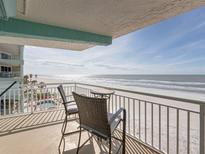 Inviting oceanfront balcony featuring comfortable seating and stunning views of the beach and ocean at 19440 Gulf Blvd # 301, Indian Rocks Beach, FL 33785