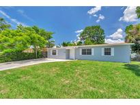 Charming single-story home with a well-maintained lawn and a classic front facade under a bright, sunny sky at 2509 W Crawford St, Tampa, FL 33614