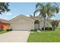 Charming single-story home with a well-maintained lawn, two car garage, and a beautiful palm tree at 2625 Brookville Dr, Valrico, FL 33596
