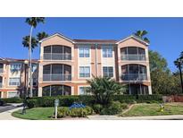 Three-story condo building with screened patios and lush landscaping at 5000 Culbreath Key Way # 1-220, Tampa, FL 33611