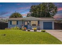 Charming single-story home featuring a well-manicured lawn, blue trim, and an inviting front porch at 5690 82Nd N Ter, Pinellas Park, FL 33781