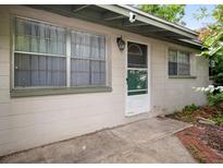 Charming single-story home featuring a bright front entrance with secure screen door and lovely curb appeal at 6006 Axelrod Rd, Tampa, FL 33634