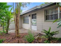 Charming single-story home featuring a bright front entrance and mature landscaping at 6006 Axelrod Rd, Tampa, FL 33634
