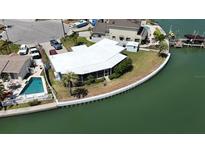 Waterfront home featuring lush landscaping, a private pool, and beautiful curb appeal at 649 Normandy Rd, Madeira Beach, FL 33708