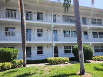 Condo building featuring multiple units with balconies and well maintained landscaping at 802 Brandy Wine Dr # 802, Largo, FL 33771