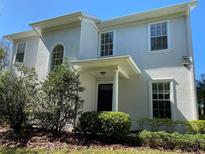 Stylish two-story home with a covered entryway, columns, and manicured landscaping at 8320 Manor Club Cir # 4, Tampa, FL 33647