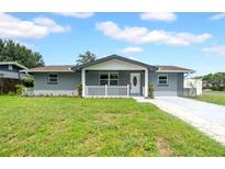 Charming single-story home featuring a well-manicured lawn, freshly painted exterior, and inviting front porch at 9801 56Th N St, Pinellas Park, FL 33782