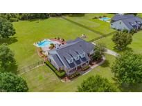 A beautiful home with a pool, mature trees and lush landscaping at 10510 Lithia Estates Dr, Lithia, FL 33547