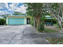 Charming single-story home with a two-car garage and well-maintained landscaping at 17807 Fallowfield Dr, Lutz, FL 33549