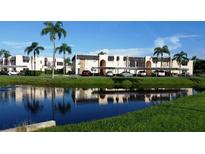 Beautiful condo community with lush landscaping and canal views offering covered parking for all residents at 221 Fernwood Cir # 221, Seminole, FL 33777
