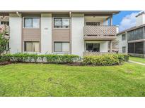 Two story condo building featuring well maintained lawn and landscaping at 2368 Flanders Way # D, Safety Harbor, FL 34695