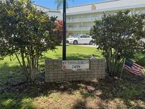 Community sign for Southern Georgian with an American flag on display at 2459 Columbia Dr # 39, Clearwater, FL 33763