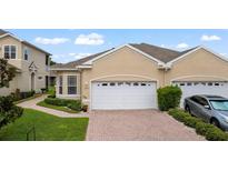 Inviting home exterior featuring a two-car garage, manicured lawn, and well-maintained landscaping at 2537 Stanhope Dr, New Port Richey, FL 34655