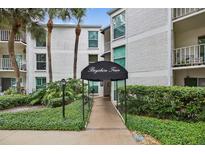 Inviting condo complex entrance with well-manicured landscaping and covered walkway at 3325 Bayshore Blvd # A31, Tampa, FL 33629