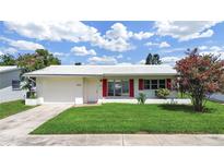 Charming single-story home with a well-manicured lawn and bright red shutters at 3515 100Th N Ter, Pinellas Park, FL 33782