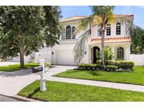 Beautiful two-story home with manicured lawn, mailbox, attached garage, and red-tile roof at 3814 W Sevilla St, Tampa, FL 33629