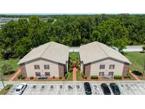 An aerial shot of a two-story apartment building, displaying its landscaping and parking at 4015 My Lady Ln # 7, Land O Lakes, FL 34638