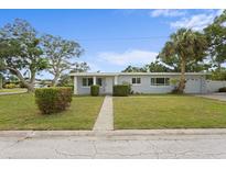 Charming single-story home with well-maintained lawn and mature trees, offering curb appeal at 4300 Maple Ne St, St Petersburg, FL 33703