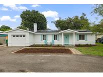 Charming home with solar panels, bright shutters, neat landscaping, and covered entry at 4753 58Th N St, Kenneth City, FL 33709