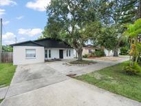 Charming single-story home with a large tree in the front yard at 8233 44Th St N N St, Pinellas Park, FL 33781