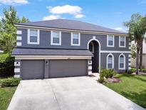 Stunning two-story home featuring a three-car garage and well-maintained landscaping at 2812 Windcrest Oaks Ct, Valrico, FL 33594