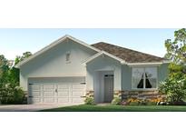 Charming single-story home with a two-car garage, stone accents, and manicured landscaping at 3340 Ivy Hollow Dr, Plant City, FL 33565