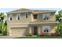 Two-story home with an attached two car garage, neutral colored exterior and landscaped yard at 3343 Ivy Hollow Dr, Plant City, FL 33565