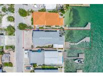 Aerial view showcasing the property's waterfront location and private dock at 340 Bay Plaza, Treasure Island, FL 33706