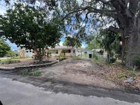 Charming single-story home with spacious driveway and mature trees in a serene neighborhood at 4720 Coronado S Way, Gulfport, FL 33711