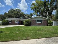 Charming single-story brick home with a well-maintained front yard and mature trees at 534 N Larry Cir, Brandon, FL 33511