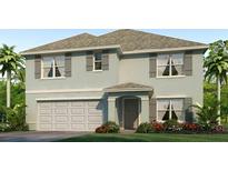 Charming two-story home with a two car garage, complemented by tasteful landscaping and a well-manicured lawn at 7710 Wheat Stone Dr, Zephyrhills, FL 33540